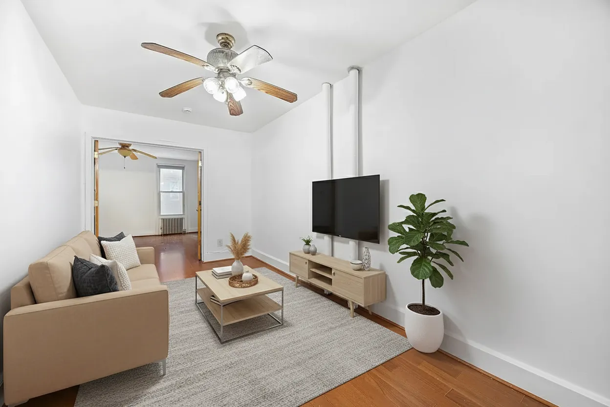 a living room with furniture and a potted plant