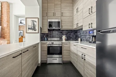 a kitchen with stainless steel appliances a stove microwave and cabinets