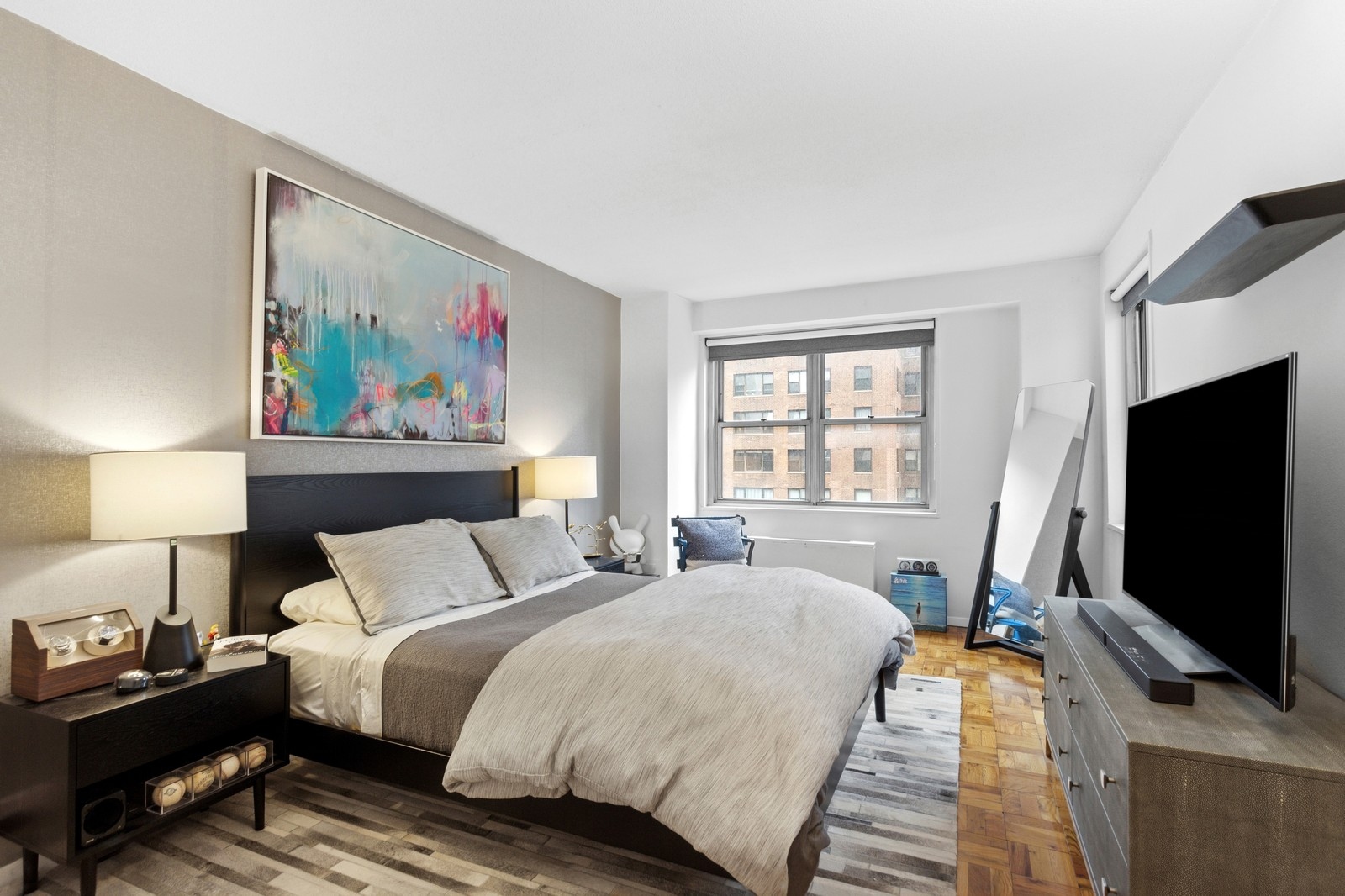 300 East 40th Street, Unit 9V Manhattan, NY 10016 - Photo 3 of 7 a bedroom with a bed and a flat screen tv