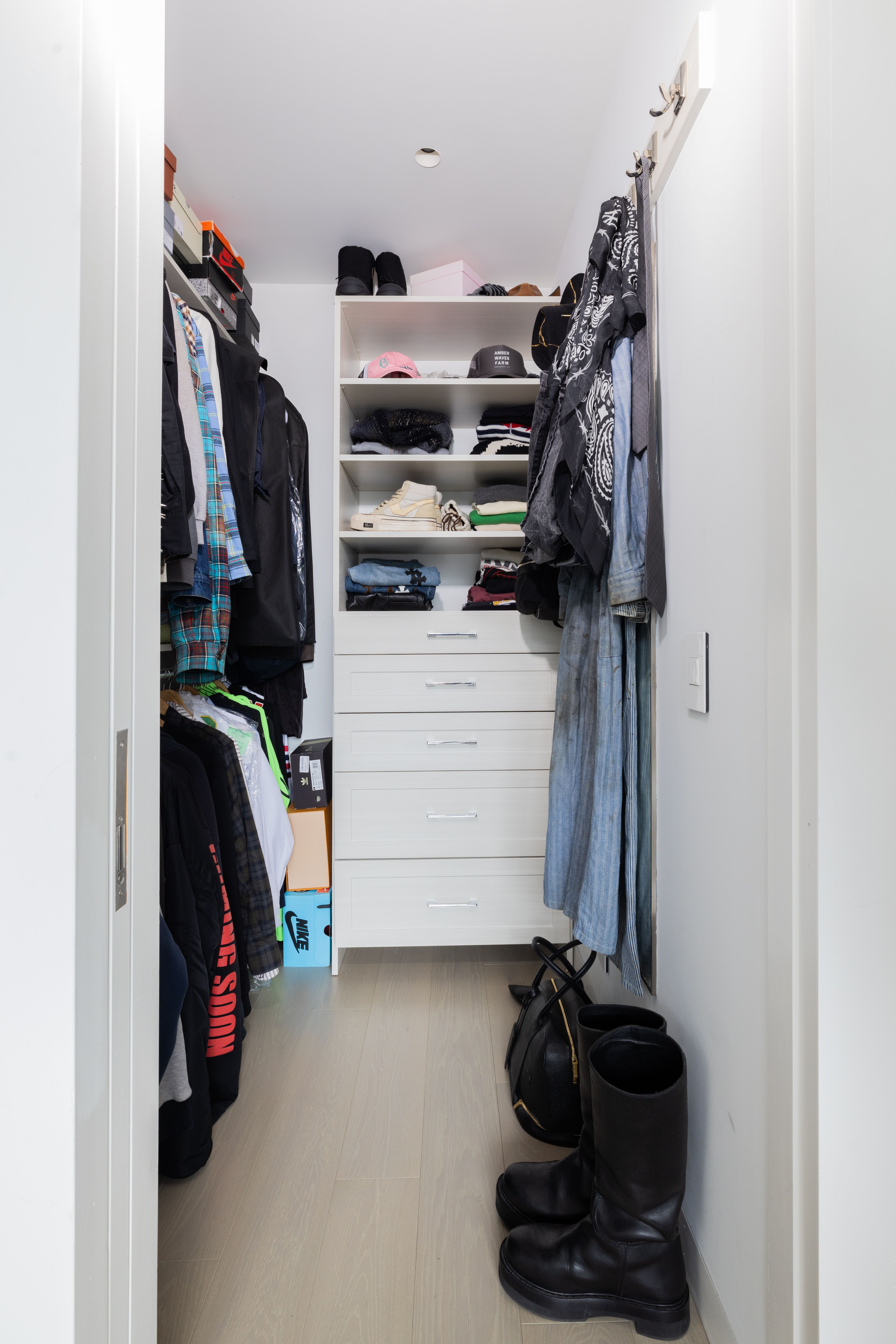 255 Hudson Street, Unit 9C Manhattan, NY 10013 - Photo 10 of 19 a view of walk in closet with clothes and shoes