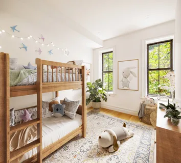 a bedroom with furniture and a large window