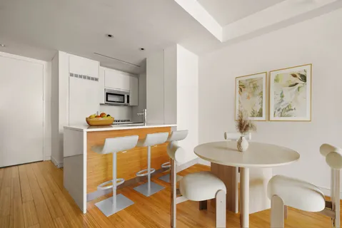 a dining room with furniture and wooden floor