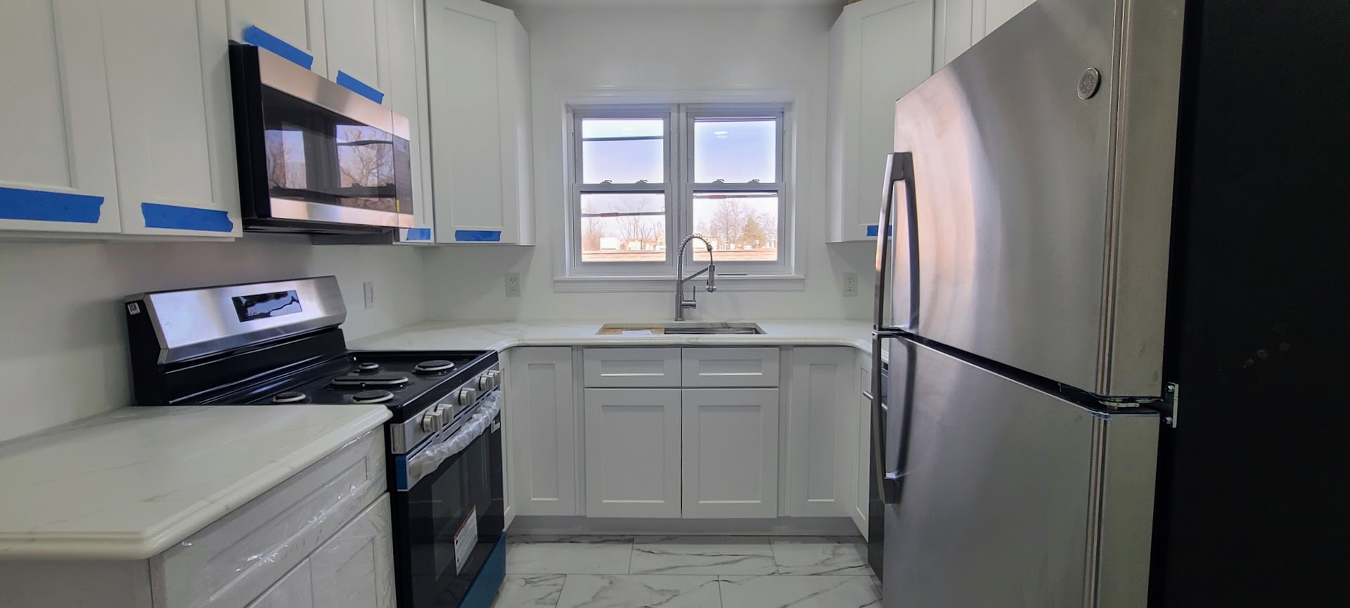 97-08 Plattwood Avenue, Unit 2 Queens, NY 11417 - Photo 1 of 10 a kitchen with stainless steel appliances granite countertop a refrigerator and a sink