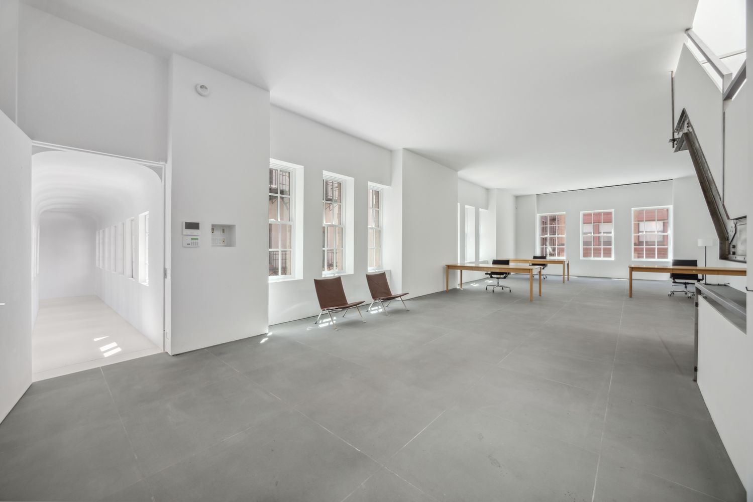 a view of a livingroom with entryway and furniture