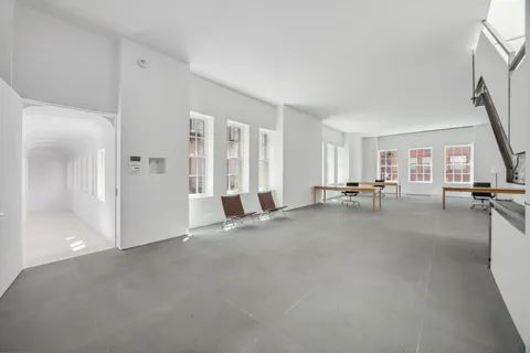 a view of a livingroom with entryway and furniture