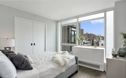 a bedroom with a large bed and a window