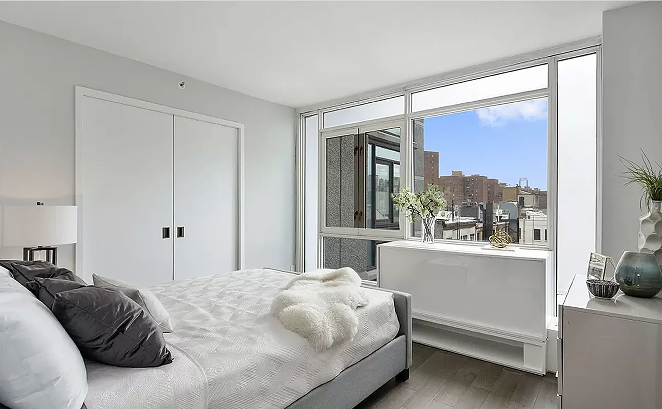 385 1st Avenue, Unit 11A Manhattan, NY 10010 - Photo 4 of 11 a bedroom with a large bed and a window