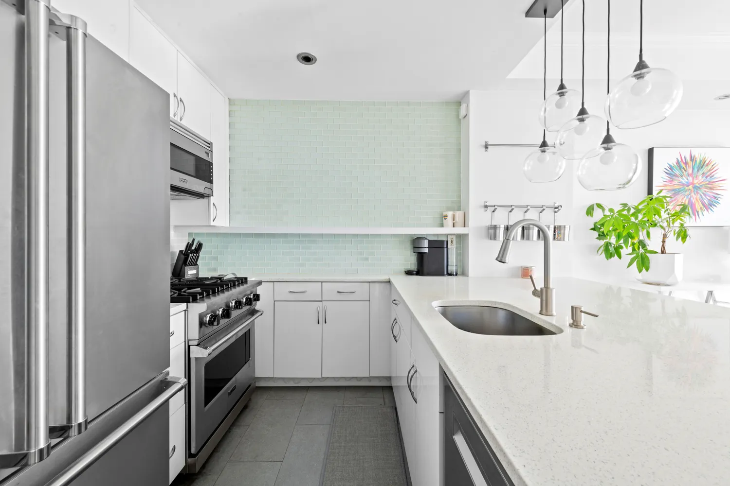 a kitchen with stainless steel appliances granite countertop a sink stove and refrigerator