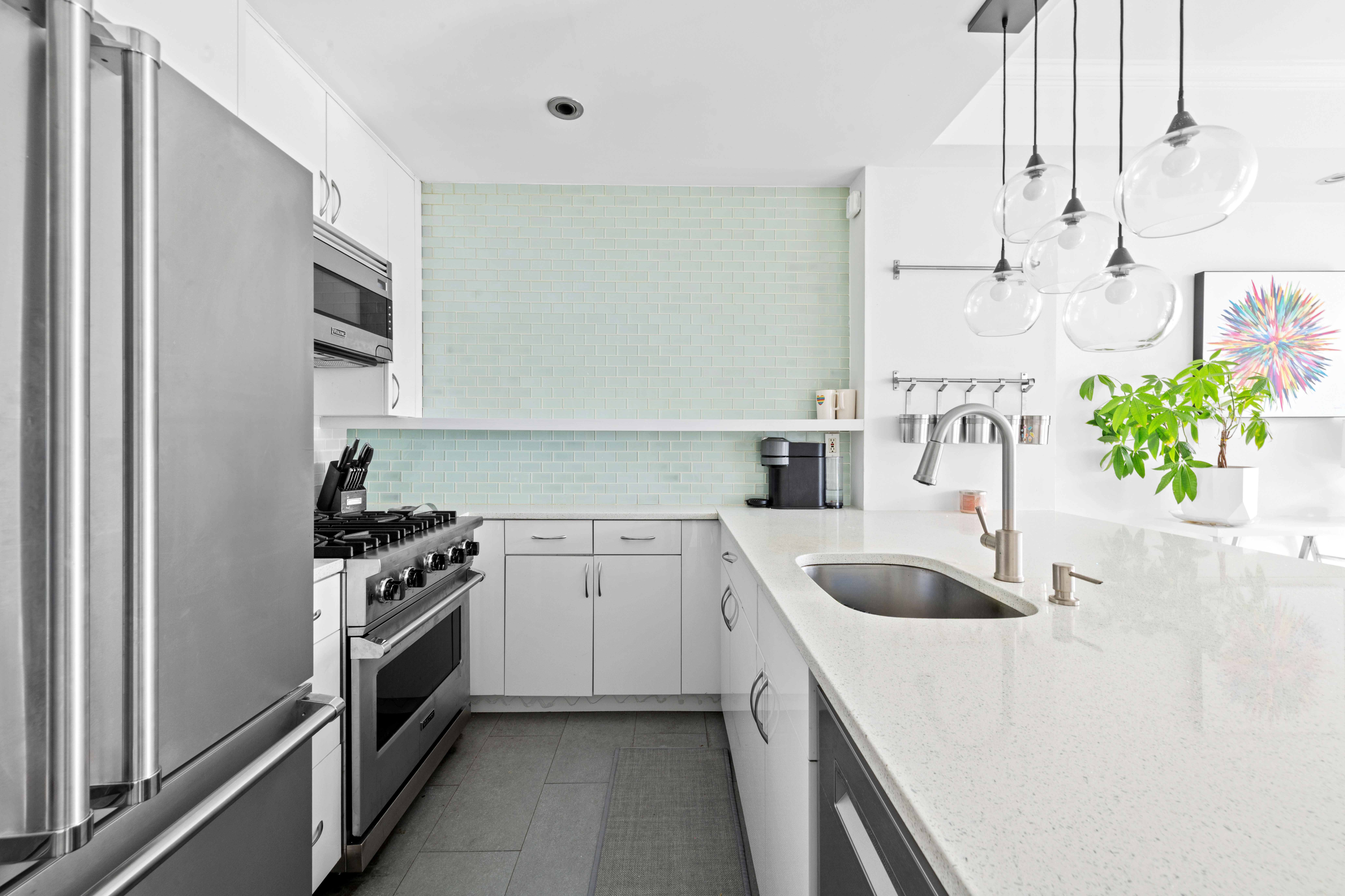 404 East 76th Street, Unit 8A Manhattan, NY 10021 - Photo 5 of 17 a kitchen with stainless steel appliances granite countertop a sink stove and refrigerator