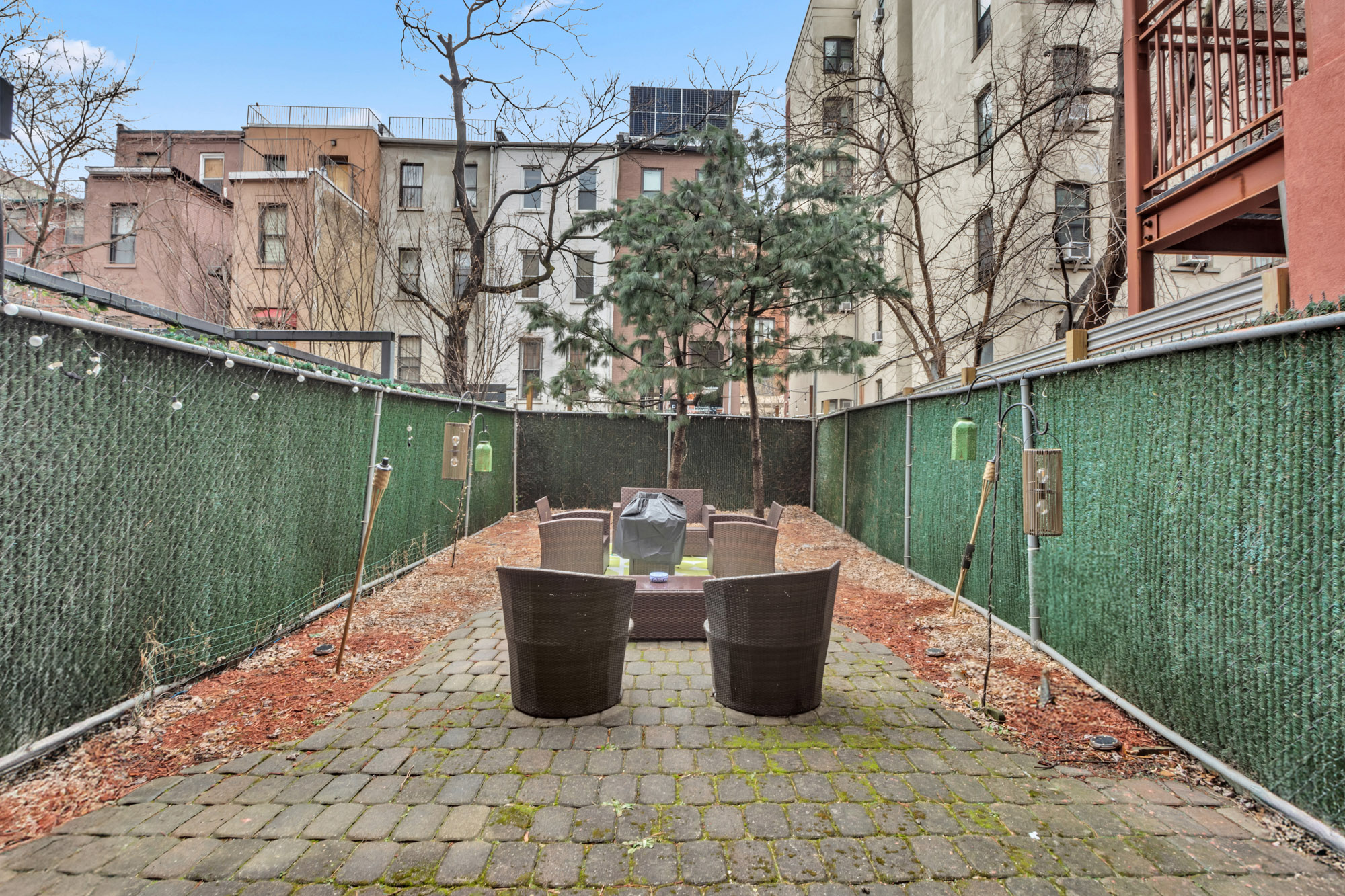 137 West 126th Street, Unit 1 Manhattan, NY 10027 - Photo 11 of 12 a view of a couches on the roof deck with a lake view