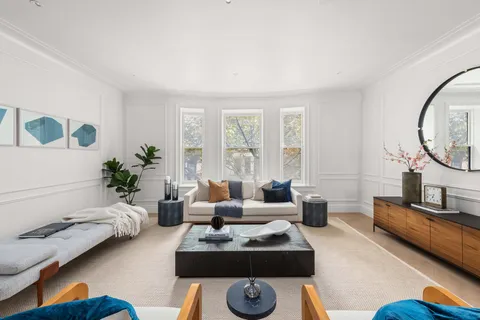 a living room with furniture rug and window