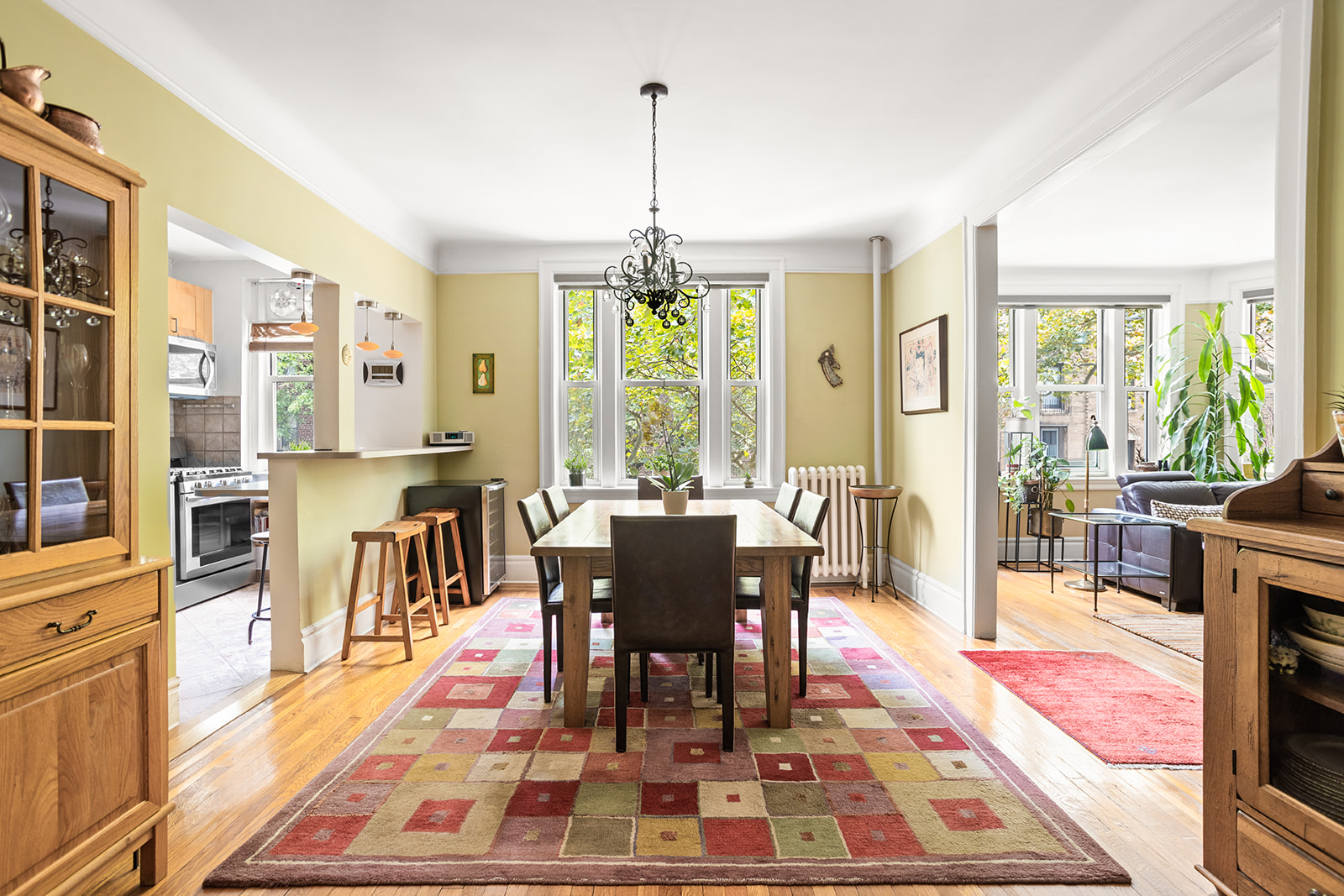 35-56 79th Street, Unit 22 Queens, NY 11372 - Photo 3 of 14 a dining room with furniture a chandelier and wooden floor