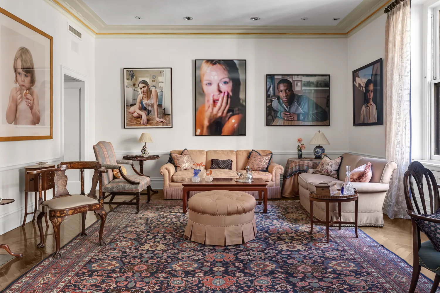 a living room with furniture and a painting on the wall