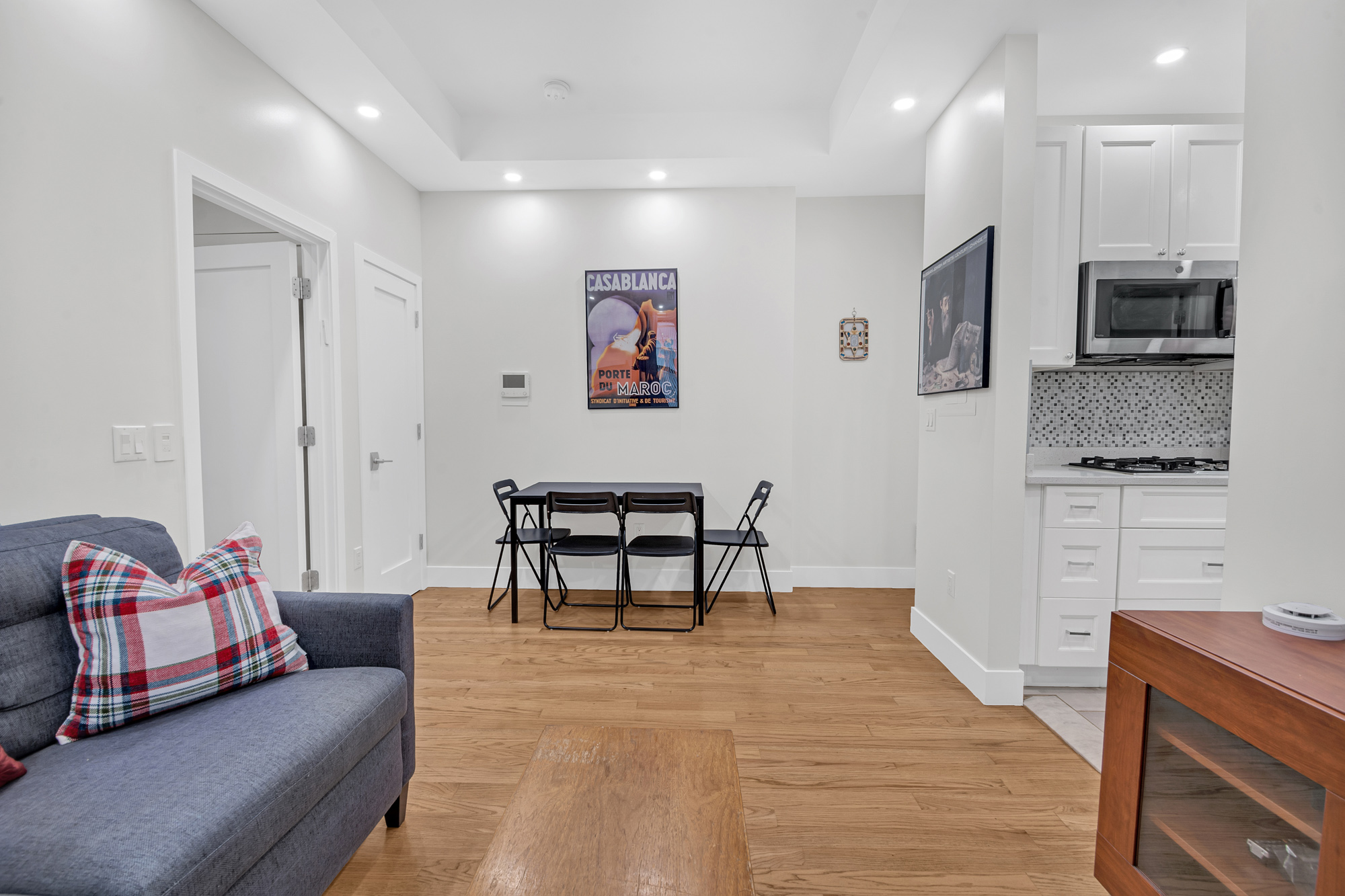244 Riverside Drive, Unit 5K Manhattan, NY 10025 - Photo 7 of 8 a living room with furniture and a flat screen tv