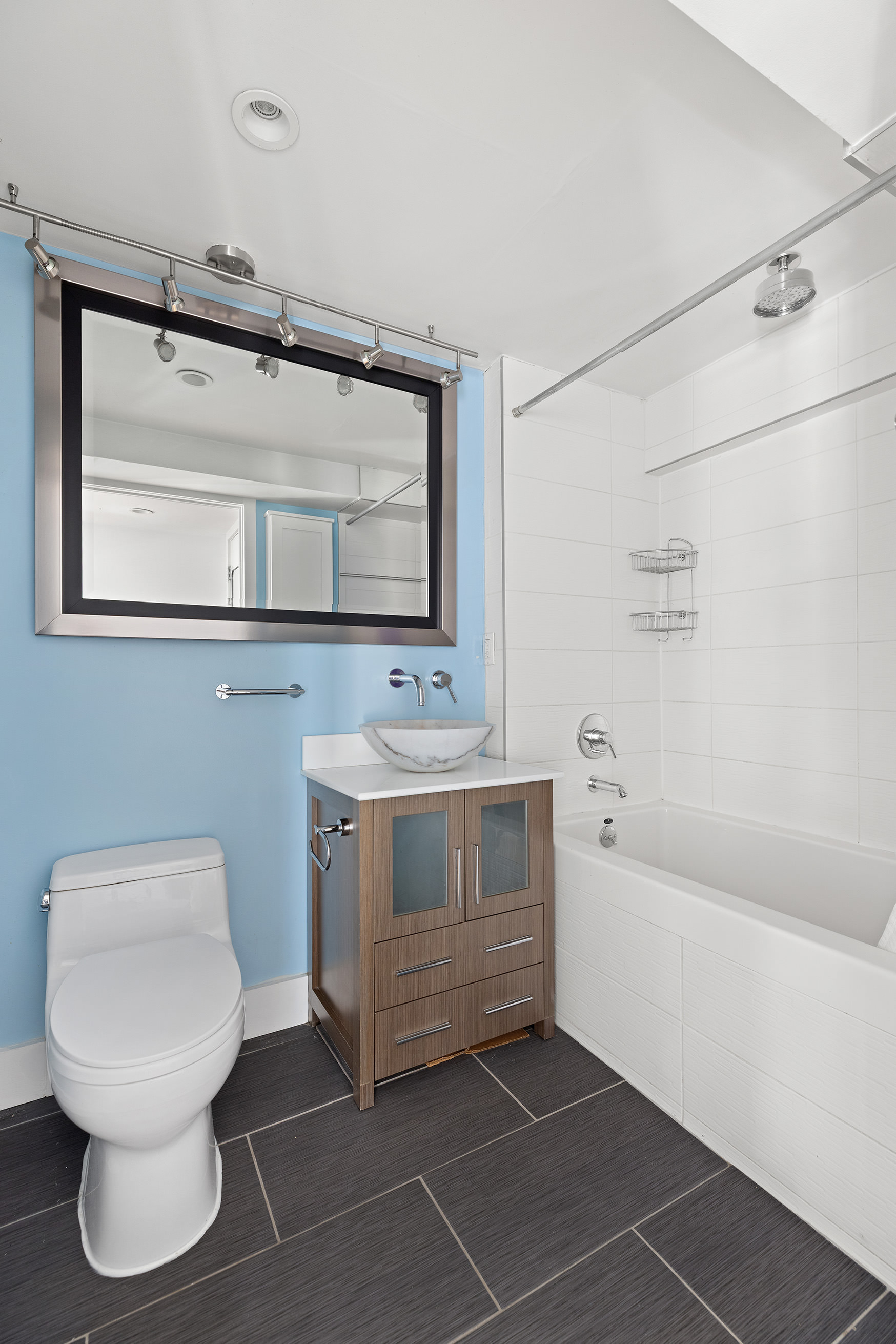 447 Humboldt Street, Unit PHB Brooklyn, NY 11211 - Photo 8 of 10 a bathroom with a toilet sink and mirror