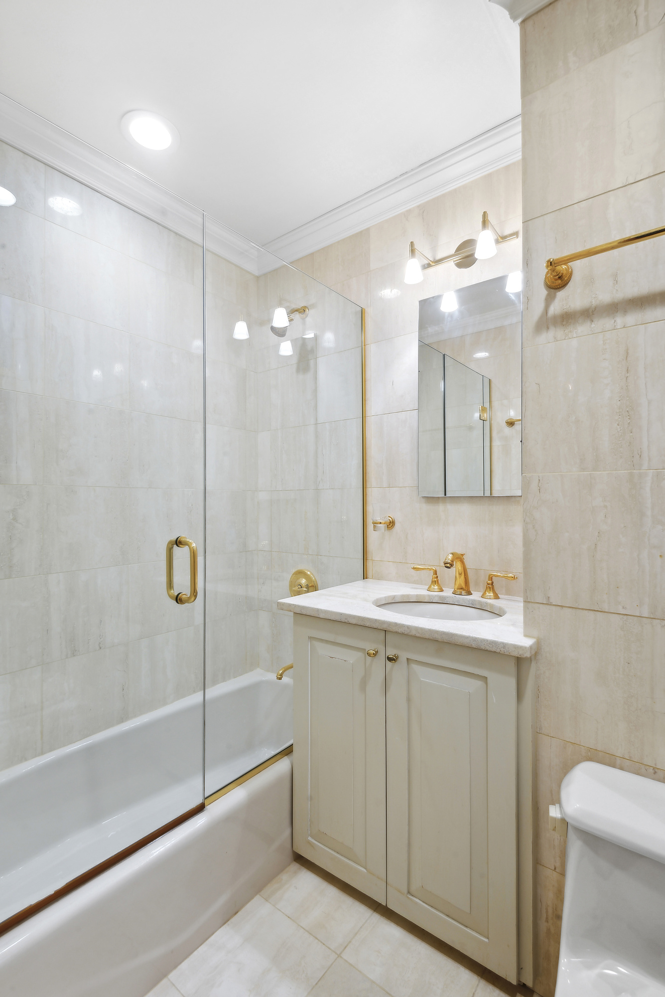 145 West 86th Street, Unit 12B Manhattan, NY 10024 - Photo 11 of 12 a bathroom with a bathtub a sink a toilet and a mirror