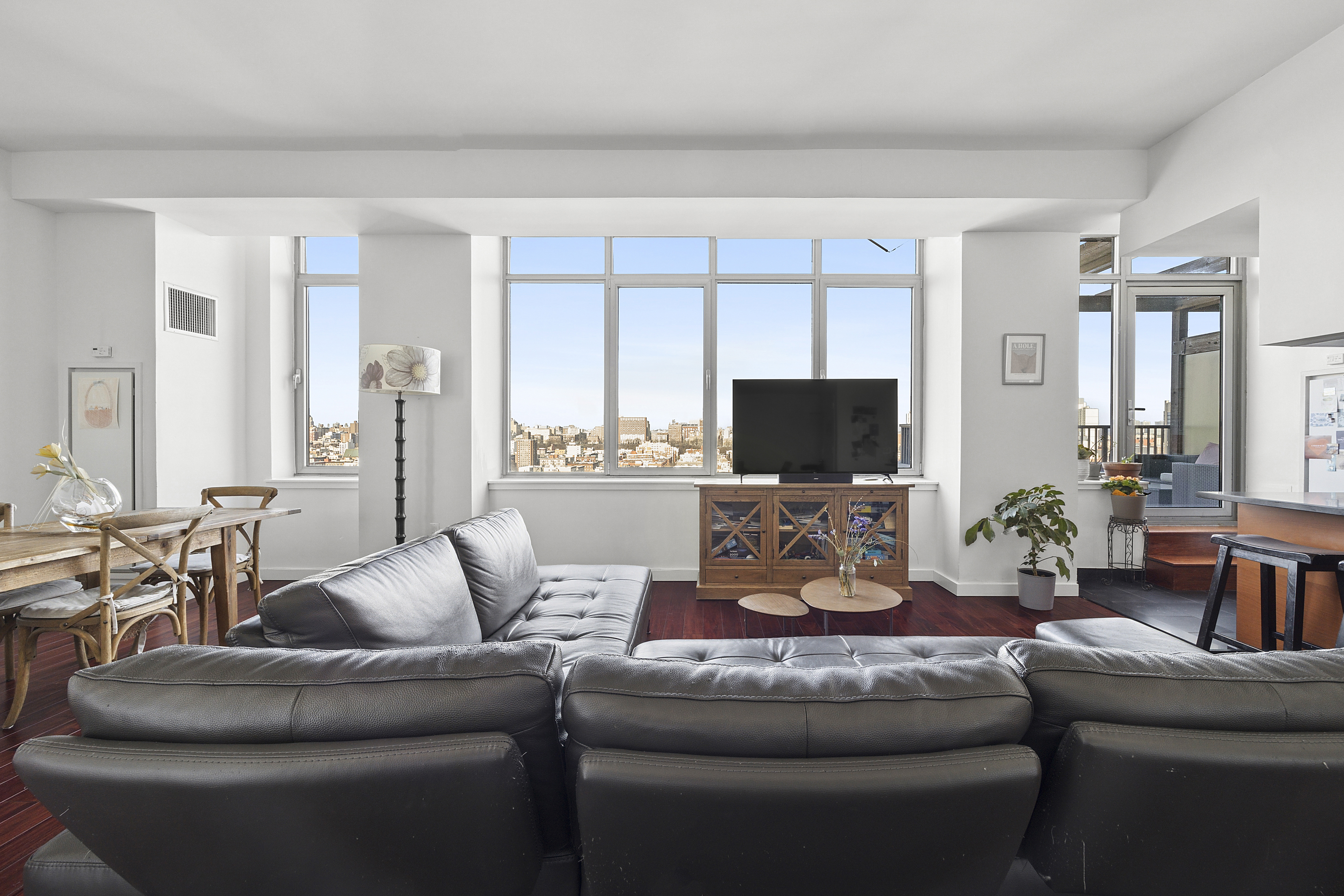 1485 5th Avenue, Unit 18/19H Manhattan, NY 10035 - Photo 2 of 21 a living room with furniture and a flat screen tv