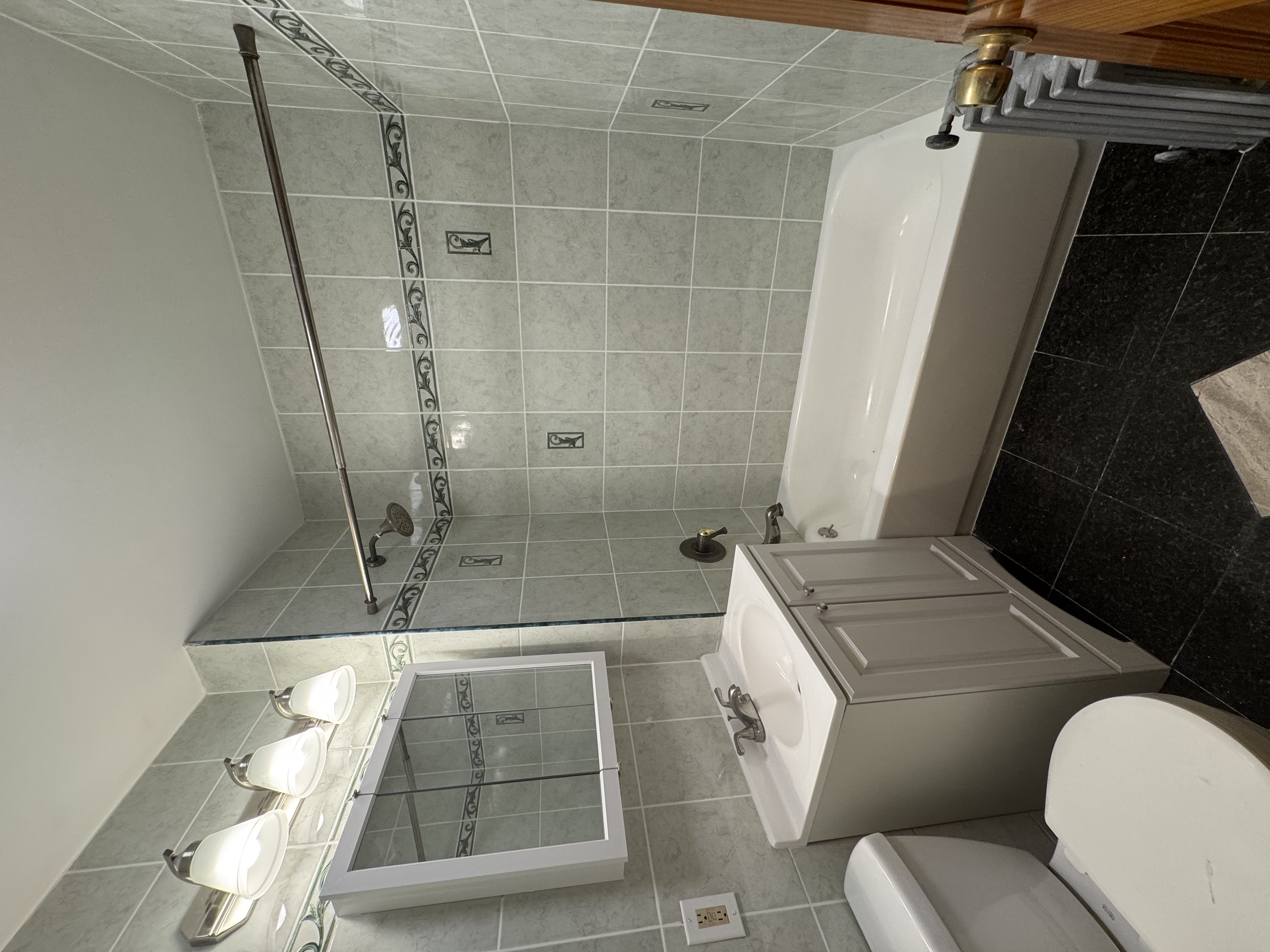 60-27 56th Road, Unit 3 Queens, NY 11378 - Photo 9 of 9 a bathroom with a sink mirror toilet and bathtub