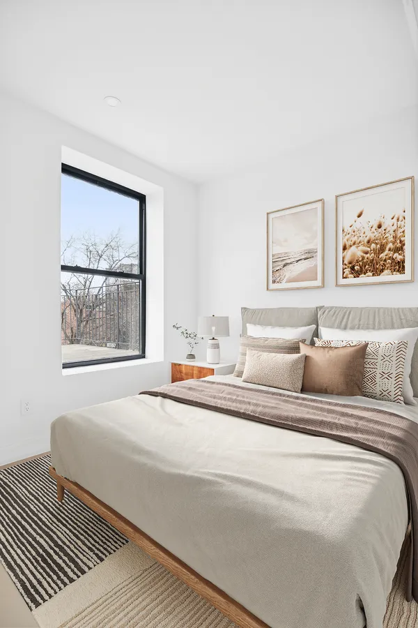 a bedroom with a bed and a window