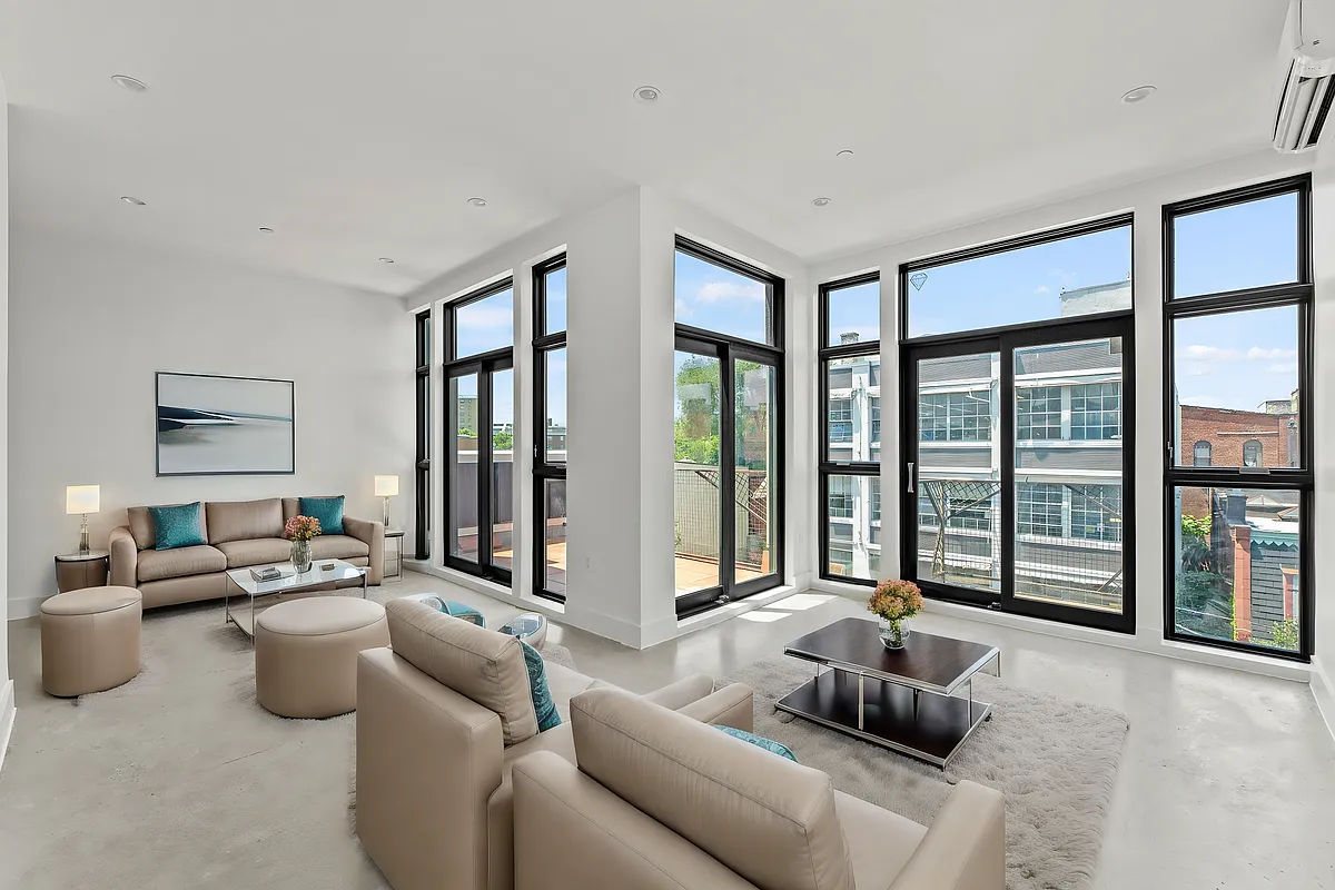 30 Belvidere Street, Unit PH4 Brooklyn, NY 11206 - Photo 2 of 8 a living room with furniture and large windows