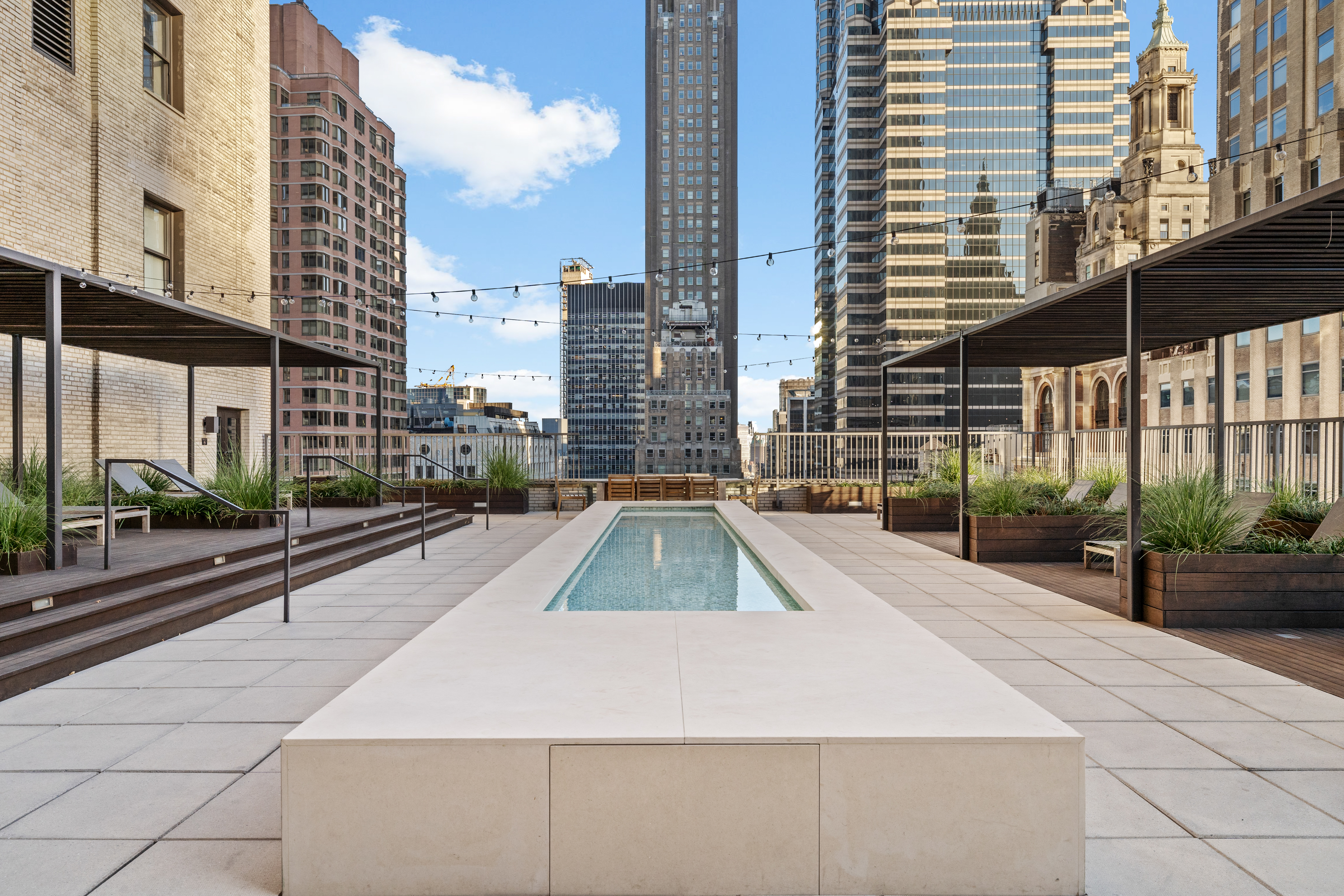 20 Pine Street, Unit 1205 Manhattan, NY 10005 - Photo 14 of 17 a view of a city with tall buildings