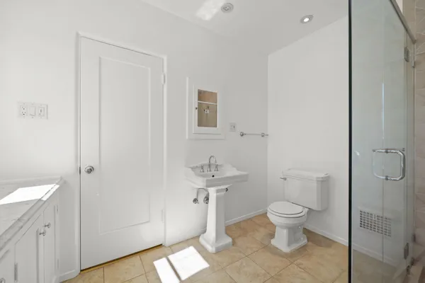 a bathroom with a shower and toilet