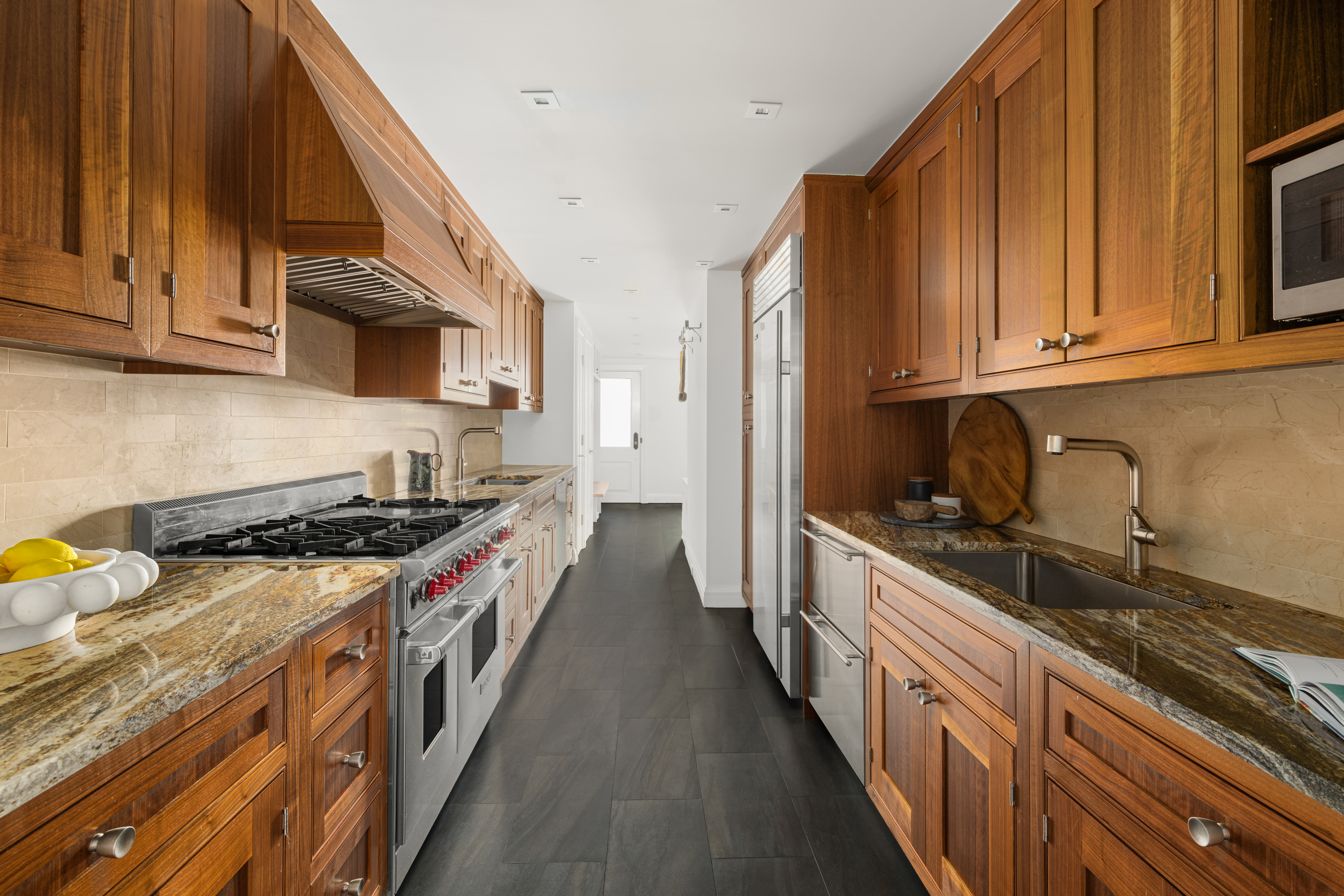 157 East 65th Street Manhattan, NY 10065 - Photo 9 of 28 a kitchen with stainless steel appliances granite countertop a stove and a sink