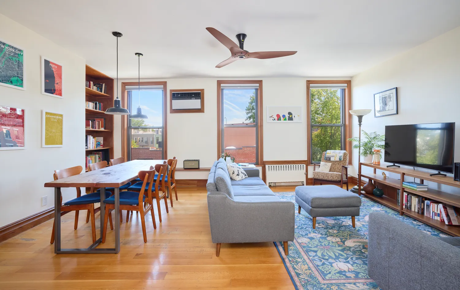 a living room with furniture kitchen view and a window
