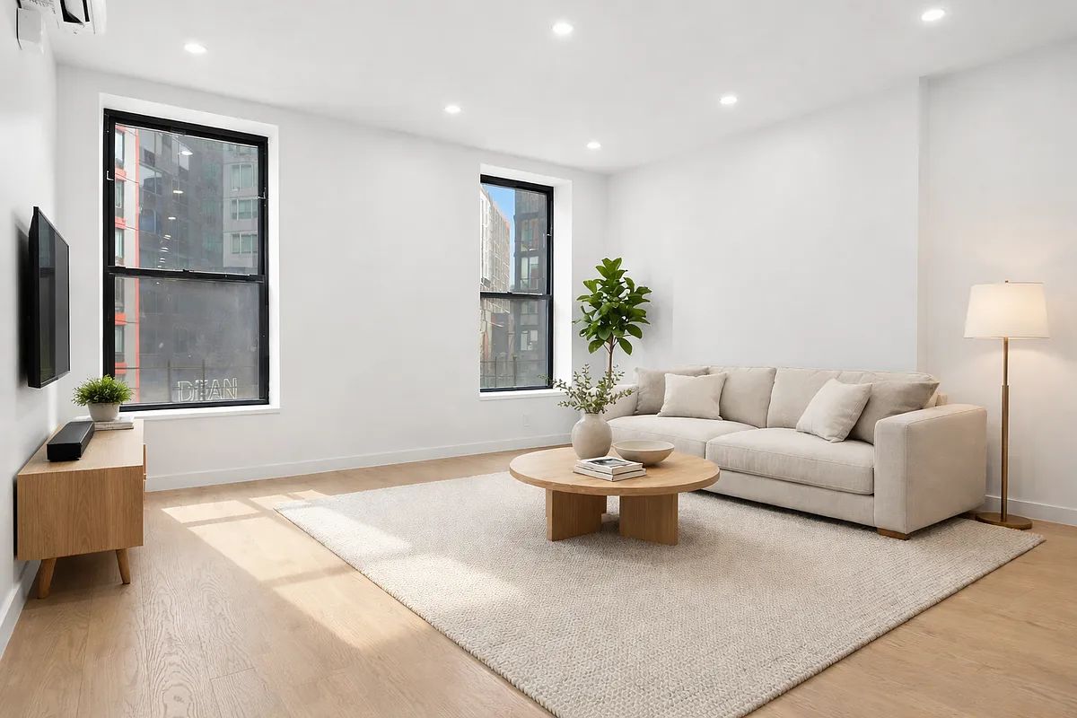 a living room with furniture and a potted plant