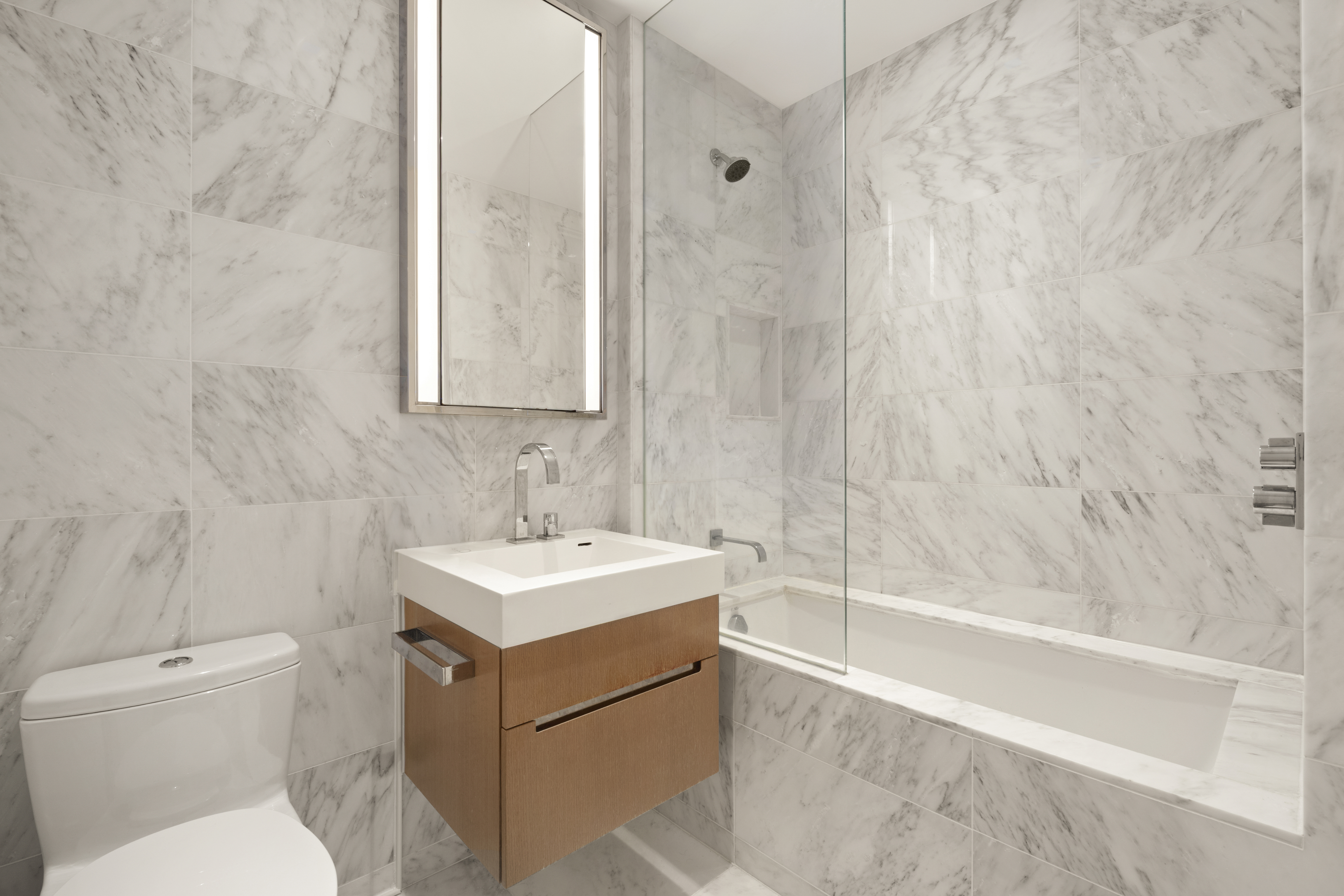 1 West End Avenue, Unit 19J Manhattan, NY 10023 - Photo 12 of 32 a bathroom with a sink toilet vanity and tub