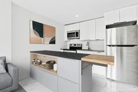 a kitchen with stainless steel appliances a refrigerator sink and microwave