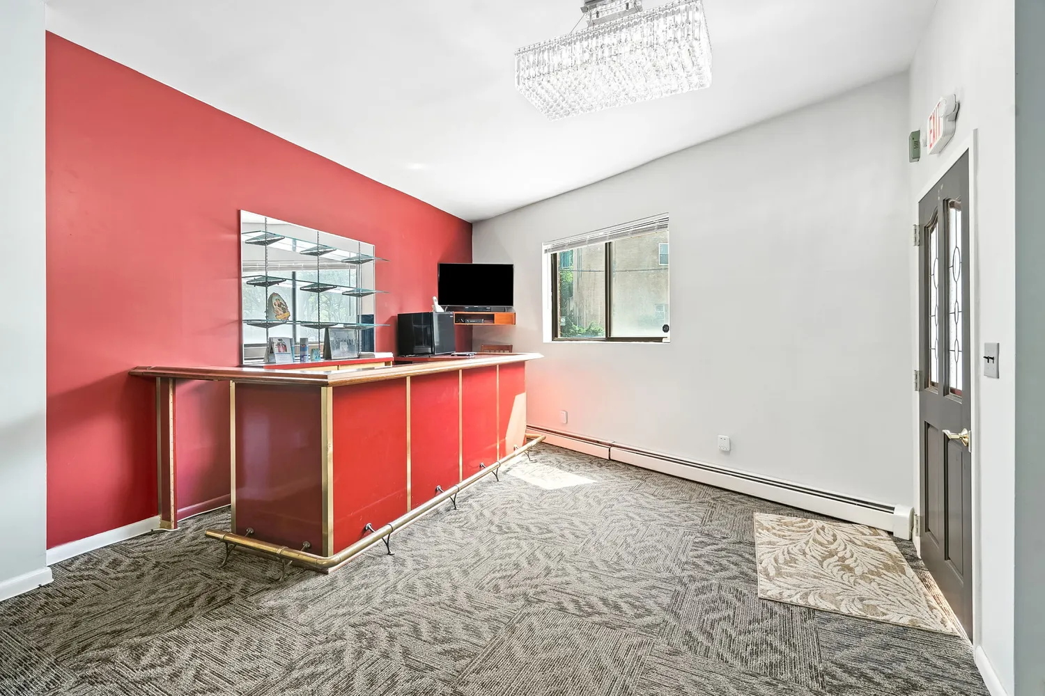 a view of kitchen with kitchen island granite countertop cabinets and flat screen tv