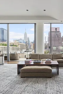 a living room with furniture and a floor to ceiling window