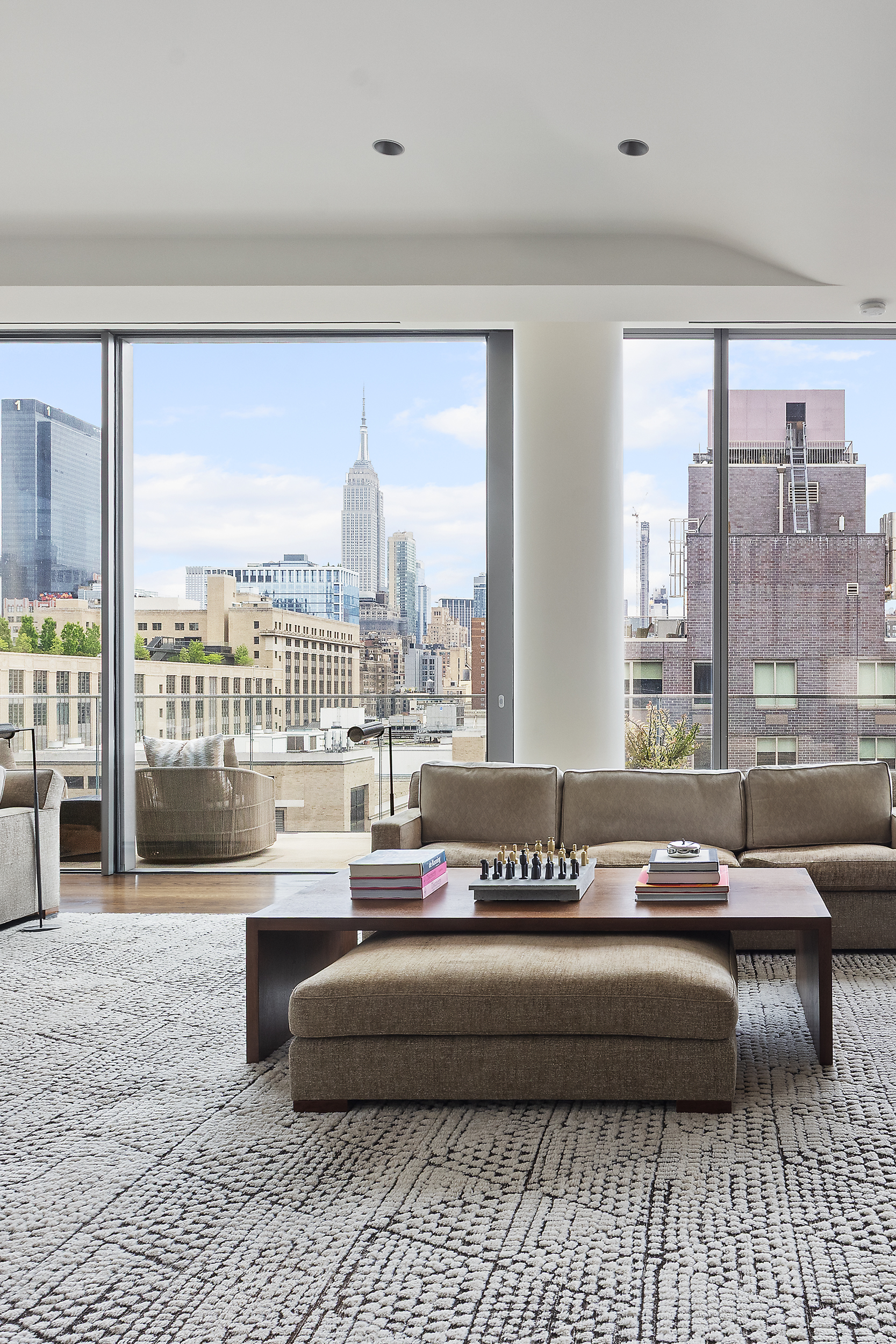 520 West 28th Street, Unit PH37 Manhattan, NY 10001 - Photo 10 of 45 a living room with furniture and a floor to ceiling window