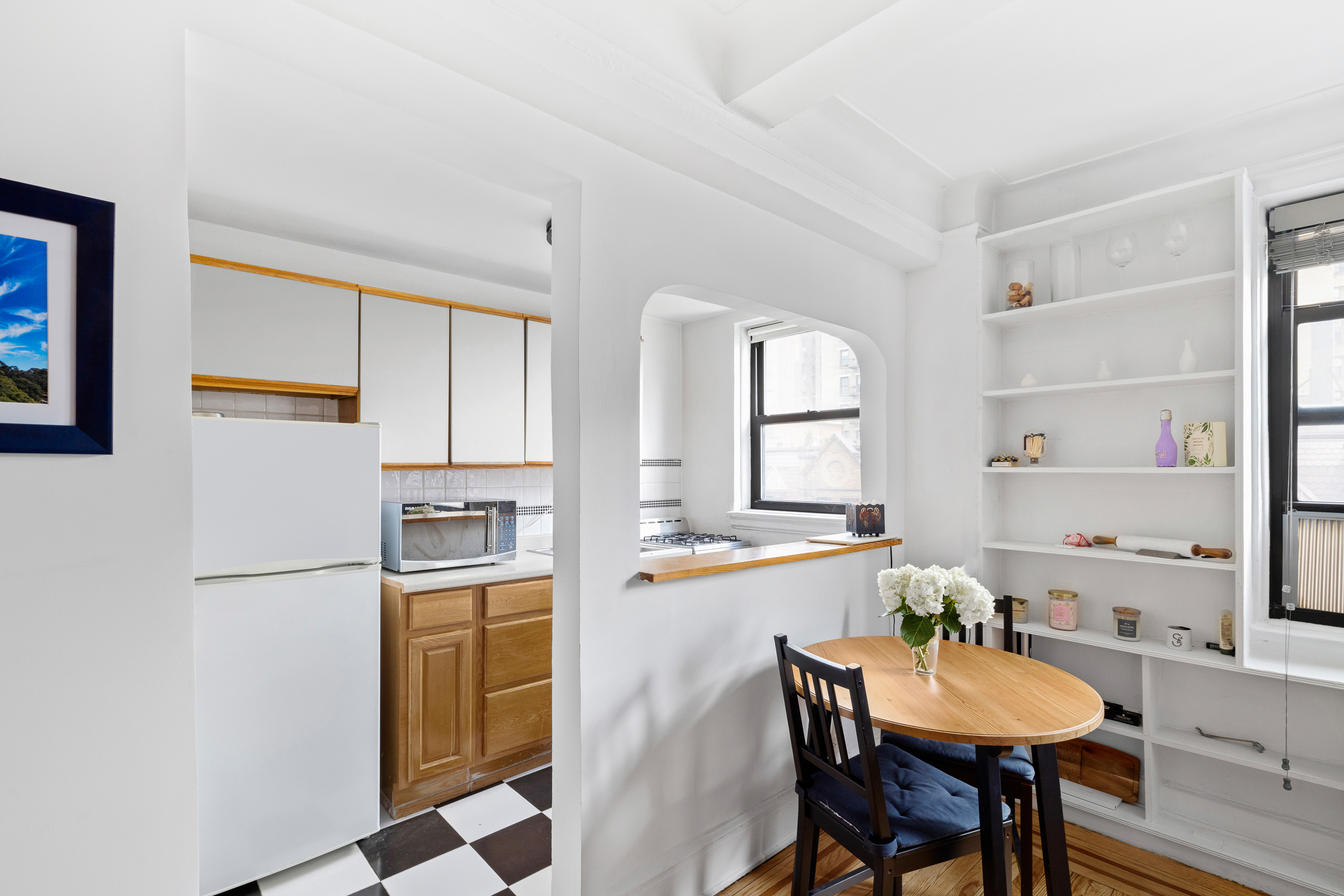 102 West 85th Street, Unit 9B Manhattan, NY 10024 - Photo 1 of 7 a kitchen with a dining table chairs and a refrigerator