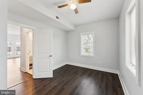 a kitchen with stainless steel appliances a sink cabinets and wooden floor