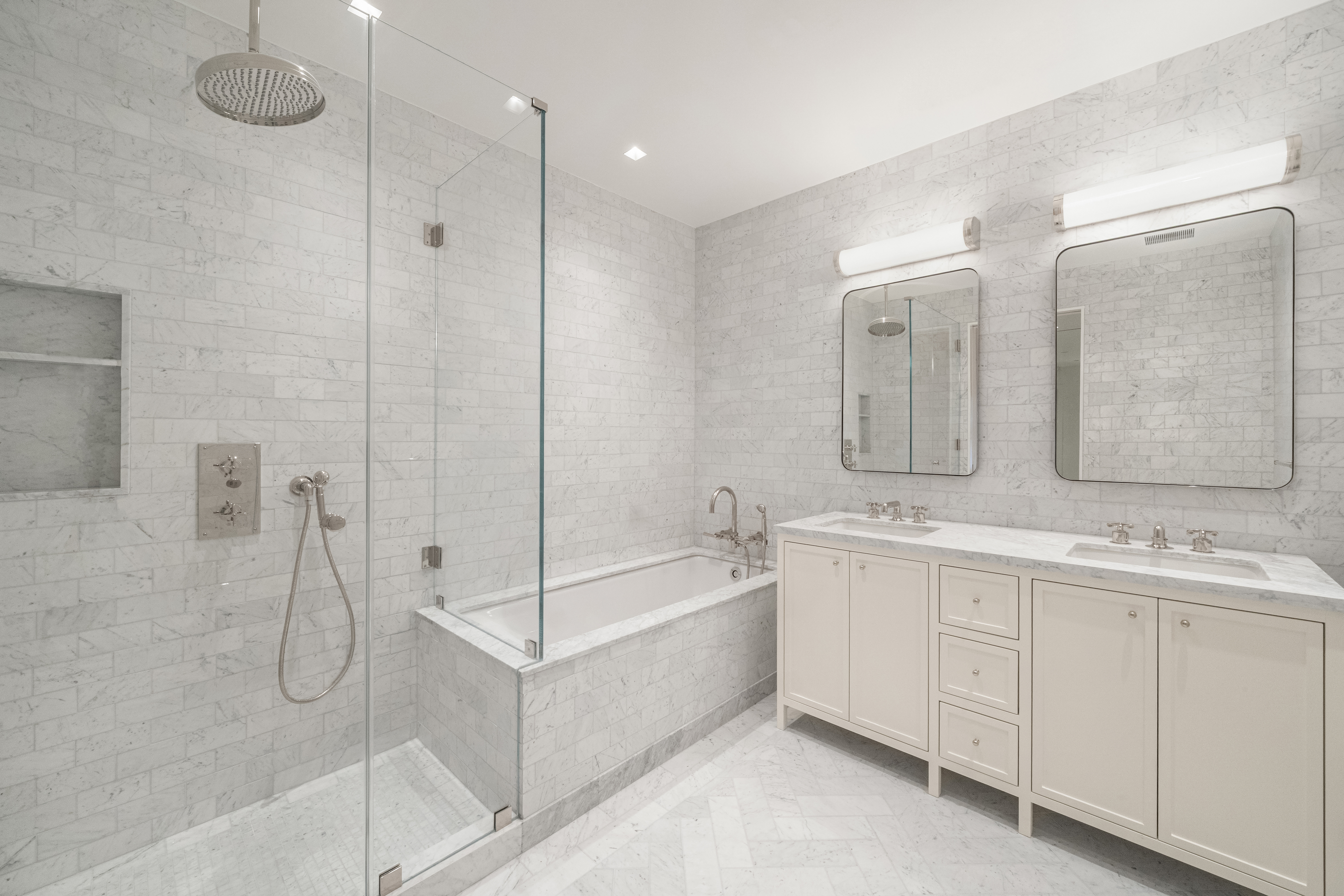 243 West Broadway, Unit 4 Manhattan, NY 10013 - Photo 7 of 12 a bathroom with a double vanity sink mirror and bathtub