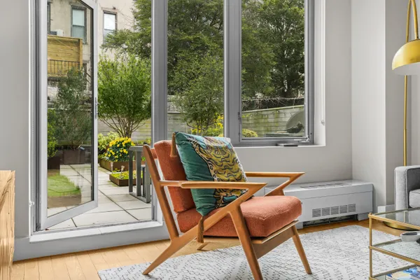 a dining room with furniture and a floor to ceiling window