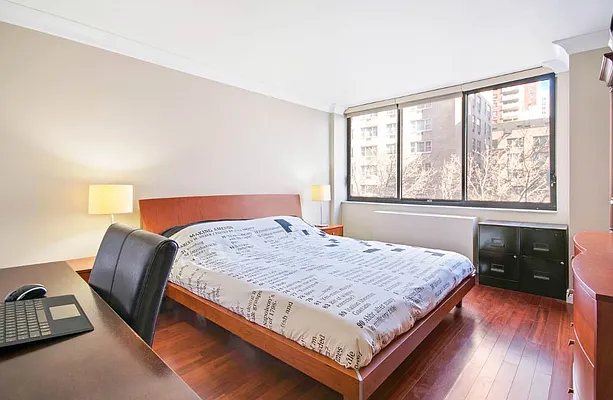 510 East 80th Street, Unit 4D Manhattan, NY 10075 - Photo 17 of 20 a bedroom with a bed and wooden floor