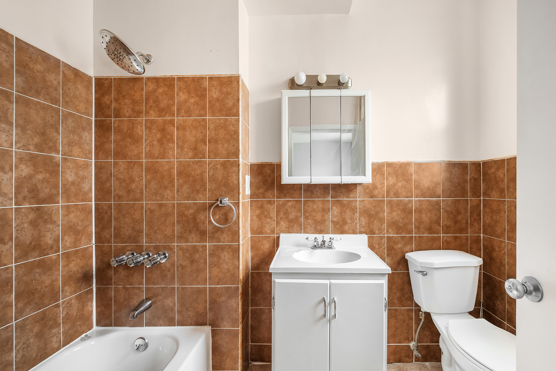 63 East 129th Street, Unit 3 Manhattan, NY 10037 - Photo 5 of 5 a bathroom with a sink a toilet and a mirror