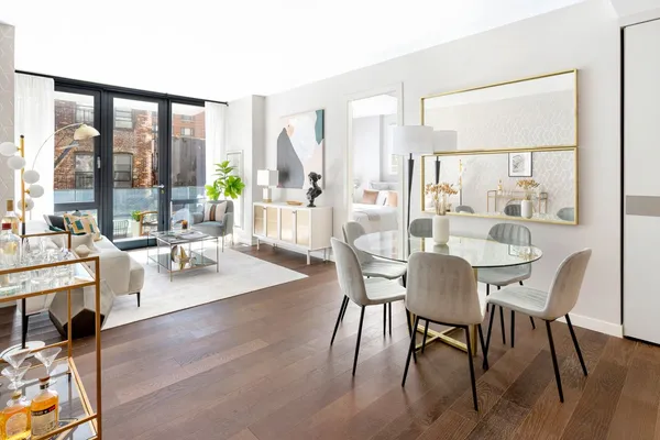 a view of a dining room with furniture large windows and wooden floor