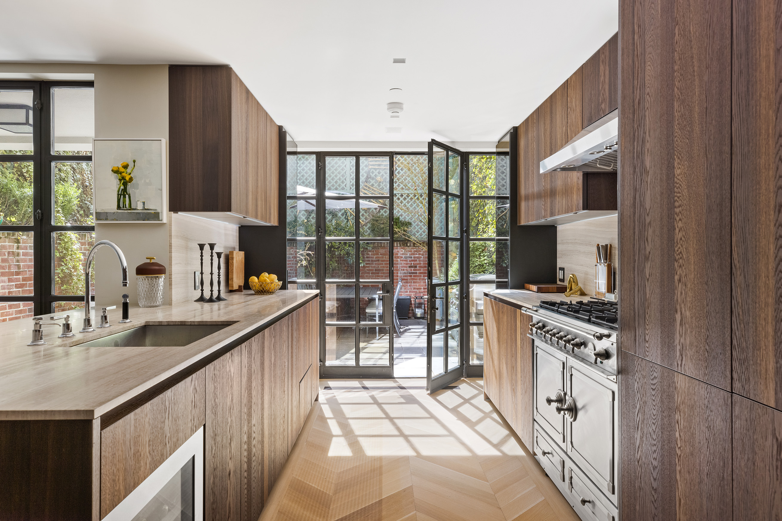 204 West 21st Street Manhattan, NY 10011 - Photo 5 of 17 a kitchen with a sink stove top oven and glass door