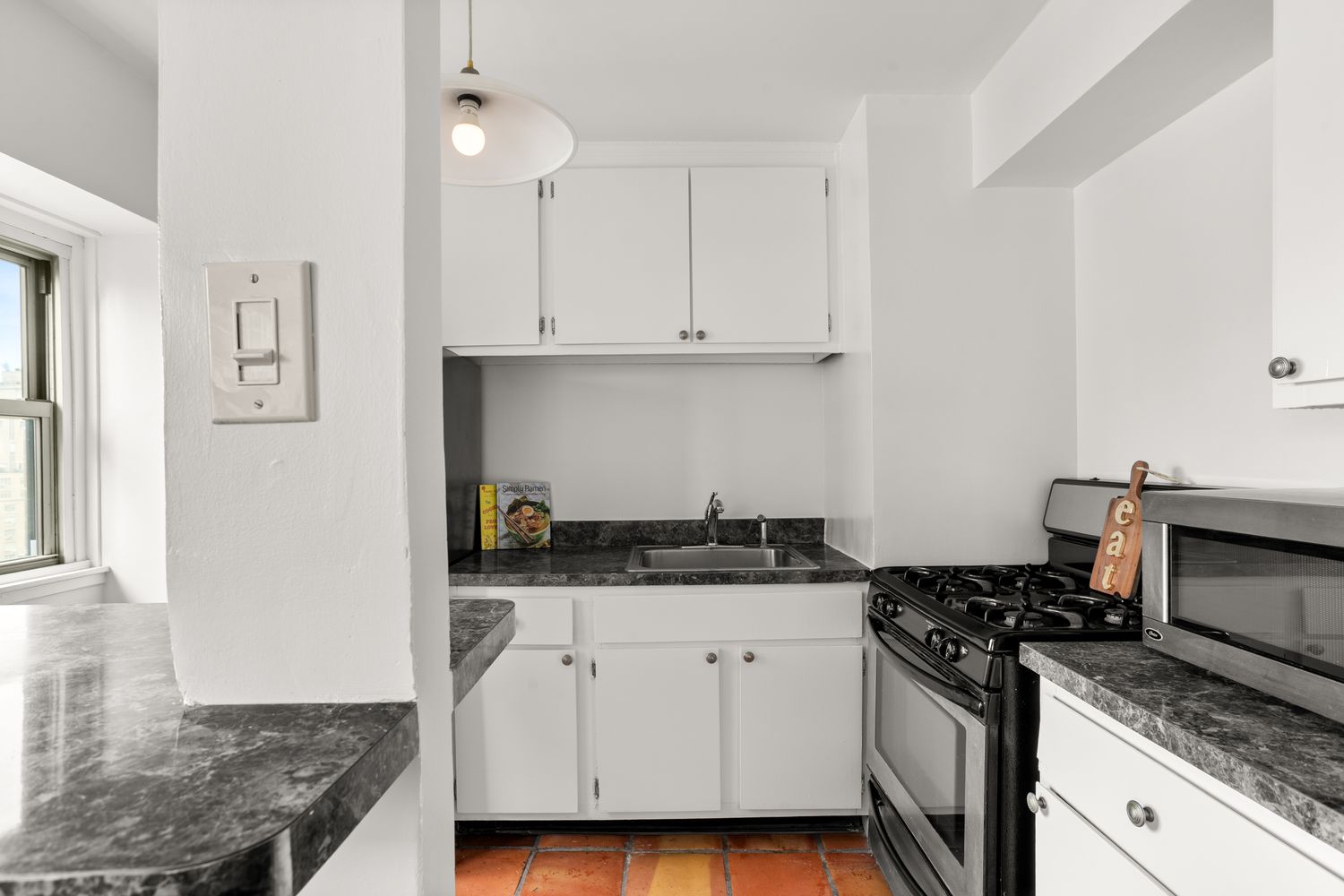 a kitchen with stainless steel appliances granite countertop a stove and a white cabinets