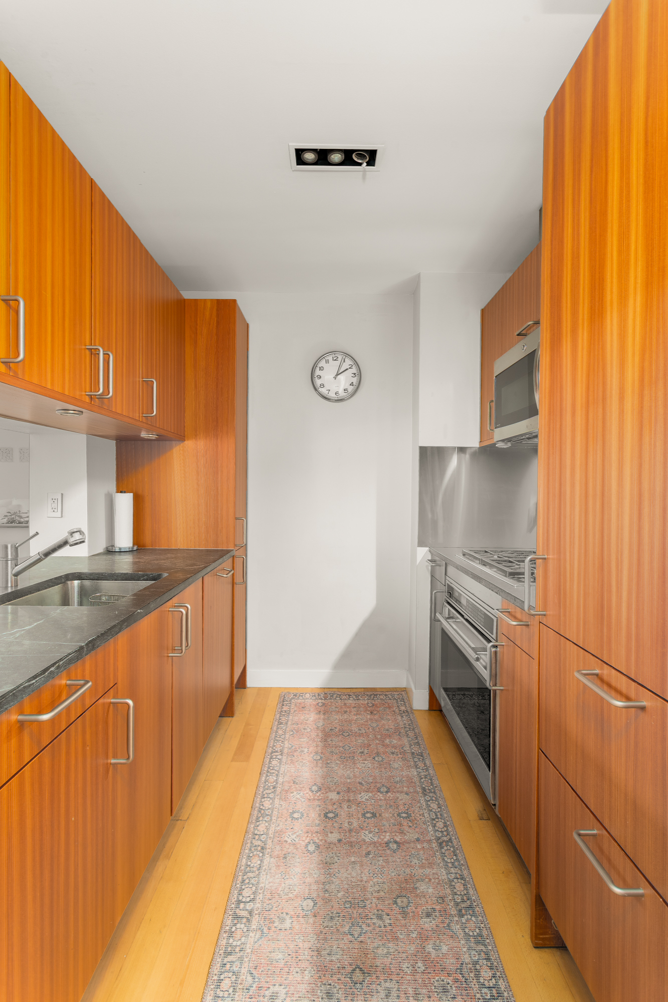 450 East 83rd Street, Unit 5K Manhattan, NY 10028 - Photo 9 of 16 a kitchen with granite countertop a refrigerator a sink dishwasher stove and oven