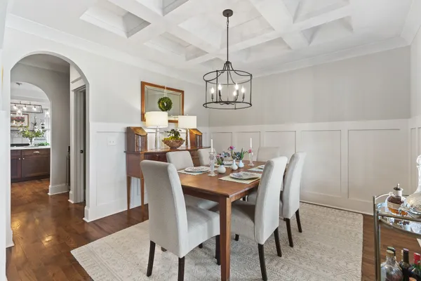 a view of a dining room with furniture wooden floor and chandelier