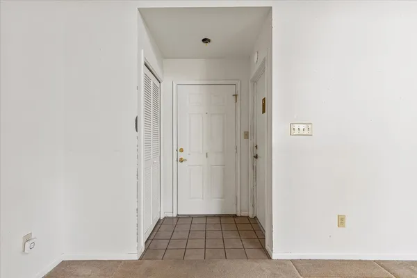 an empty room with windows and fireplace