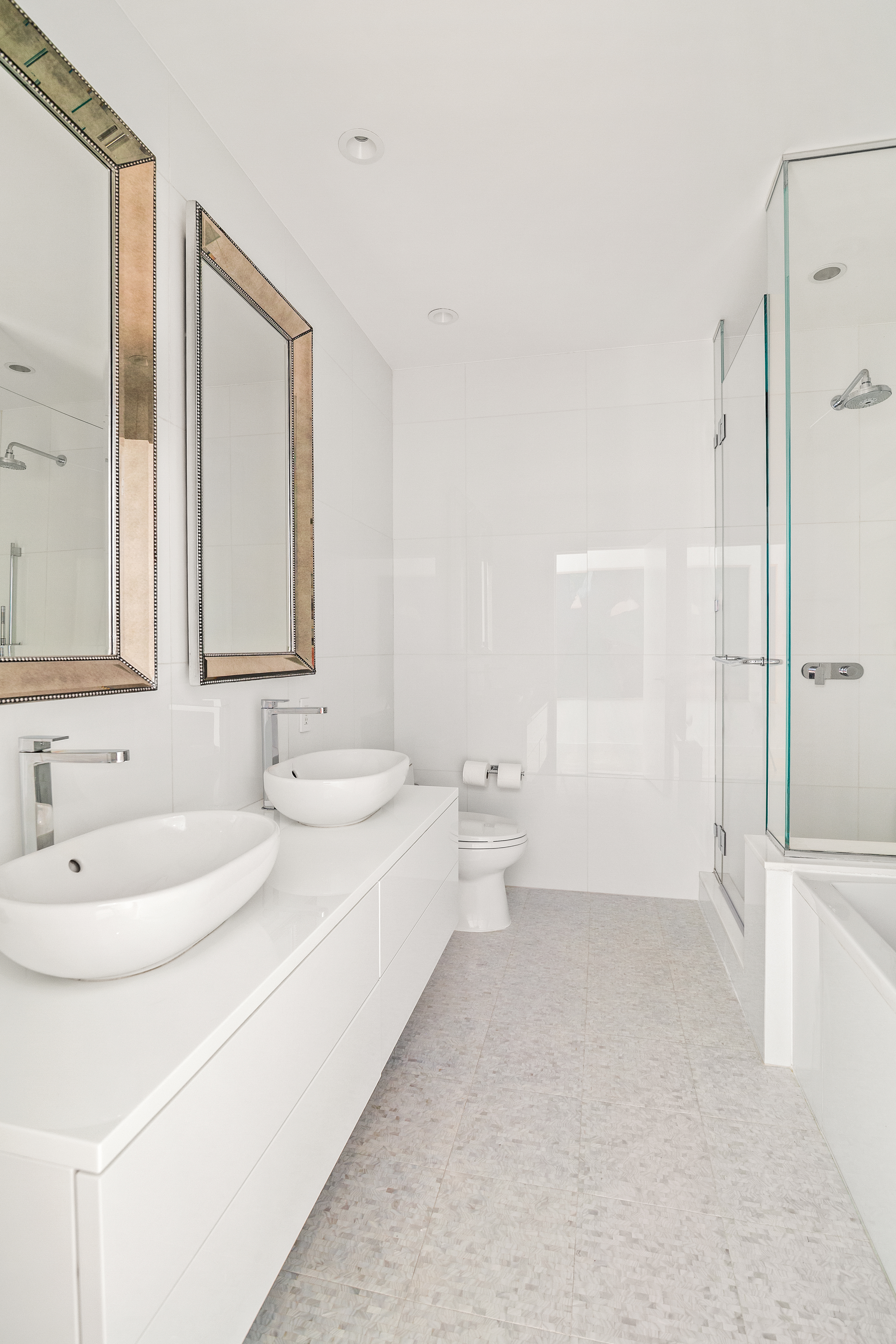 15 Broad Street, Unit 3120 Manhattan, NY 10005 - Photo 7 of 15 a bathroom with a bathtub sink mirror and toilet