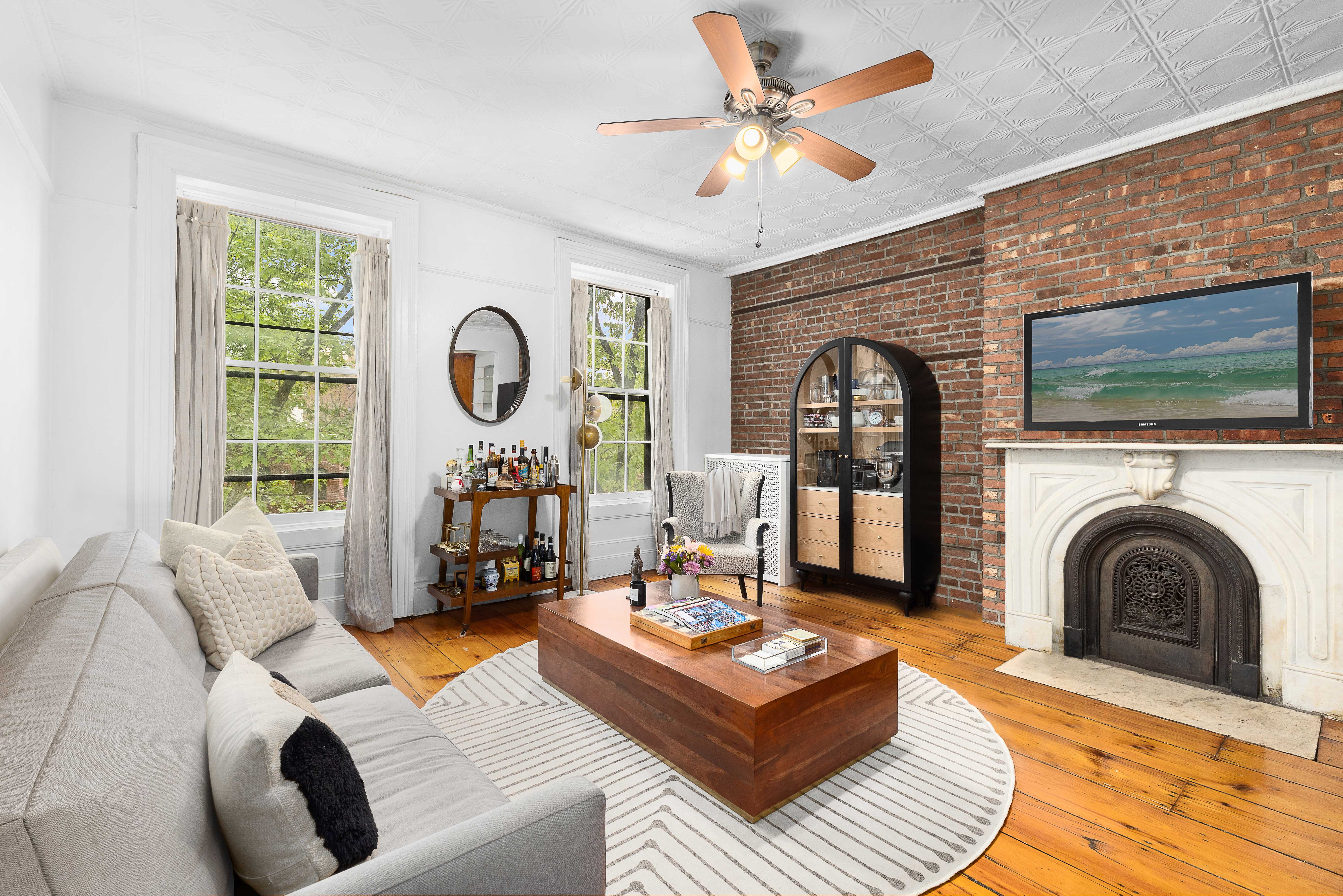 144 Baltic Street Brooklyn, NY 11201 - Photo 6 of 14 a living room with fireplace furniture and a flat screen tv