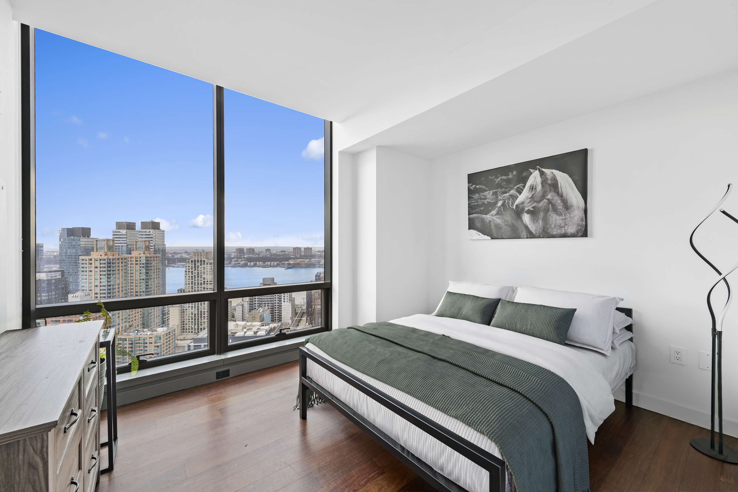 200 West 67th Street, Unit 32C Manhattan, NY 10023 - Photo 4 of 17 a bedroom with a large bed and a large window