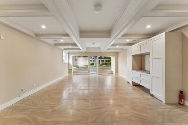 an empty room with windows and fireplace